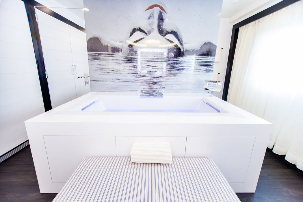 White therapy room on Saluzi designed for beauty and wellness treatments.
