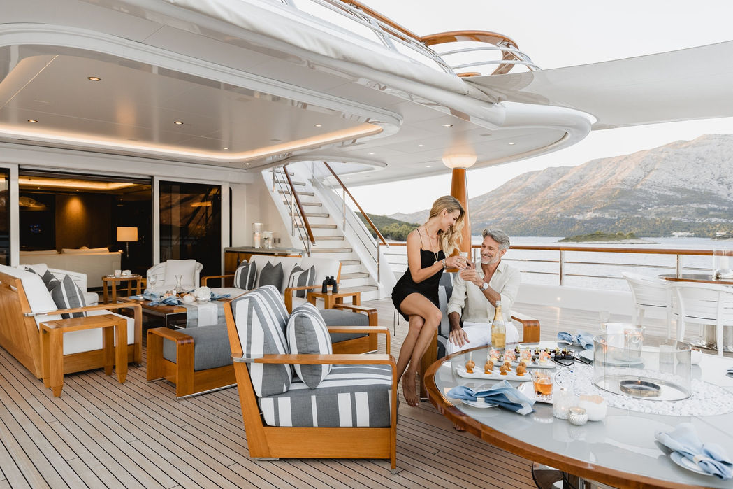 al fresco dining table on Aquila’s aft deck overlooking the sea