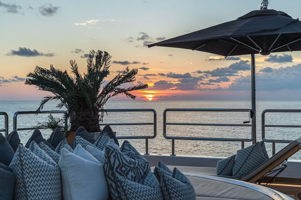Elevated foredeck lounging area aboard Sealion with umbrellas and seating.