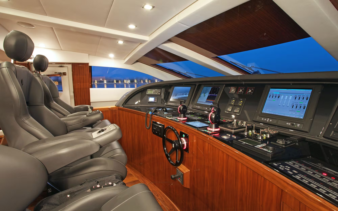 Helm station of Phoenician yacht featuring navigation displays and captain seating