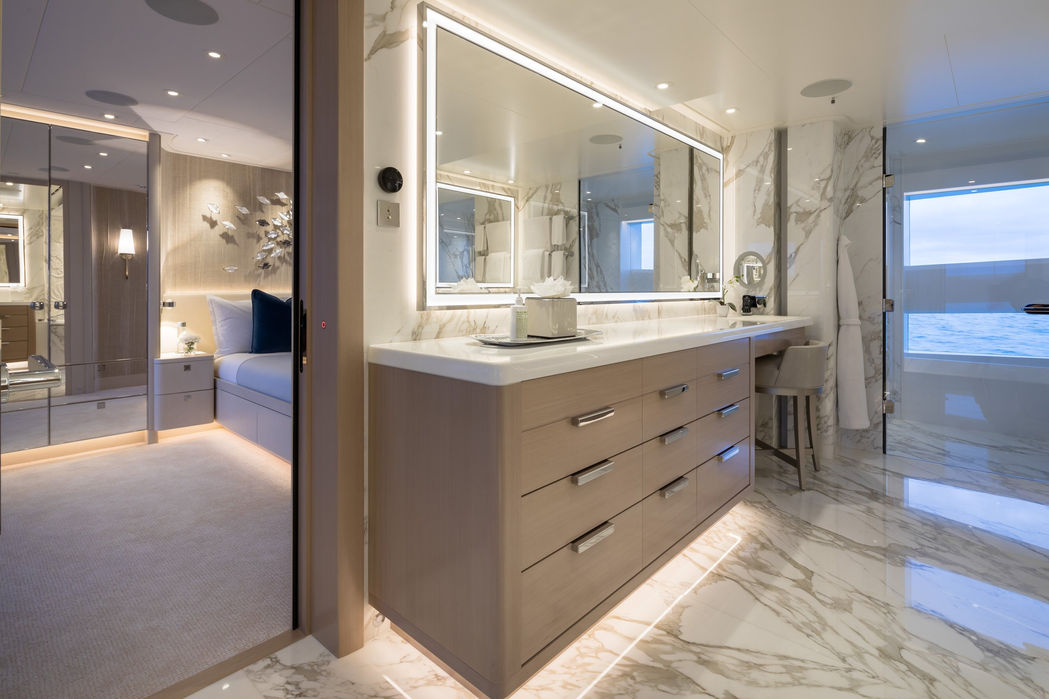 Modern guest bathroom on Santoshi superyacht with marble details and spacious vanity area.