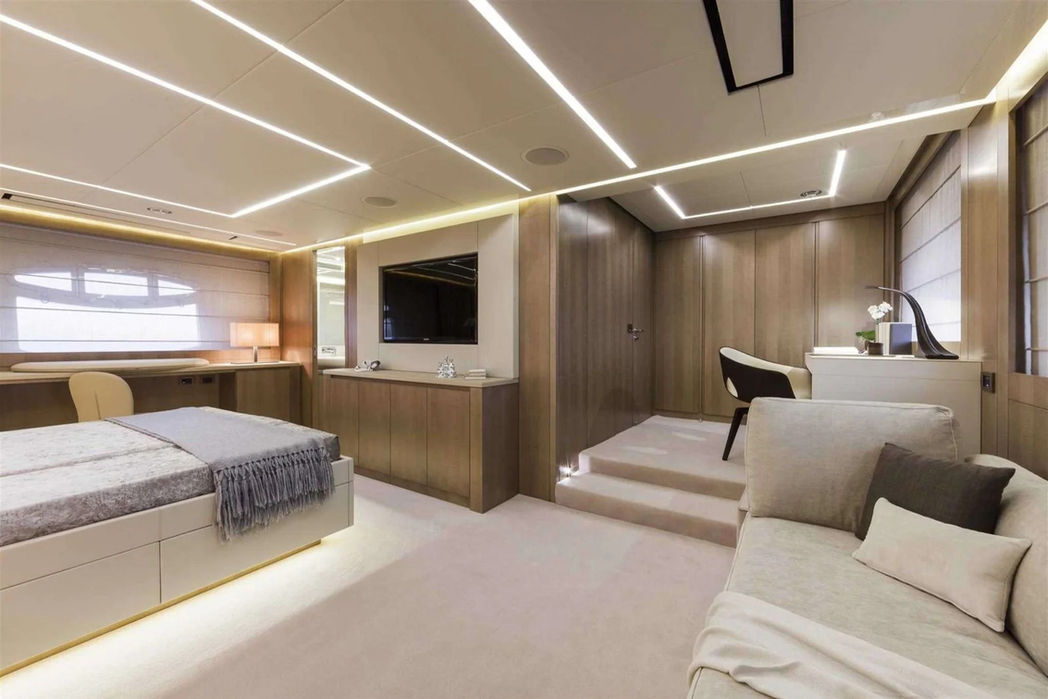 Spacious VIP cabin onboard the Pershing 108 with warm lighting and premium finishes.