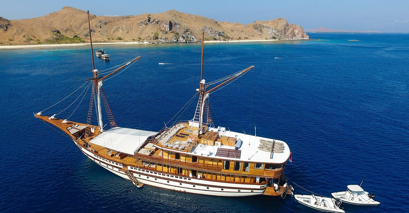 Aerial view of Prana by Atzaro luxury phinisi yacht cruising in Indonesia