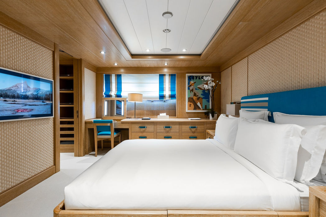 VIP suite aboard Clelia III featuring a spacious bed, soft lighting, and modern design.