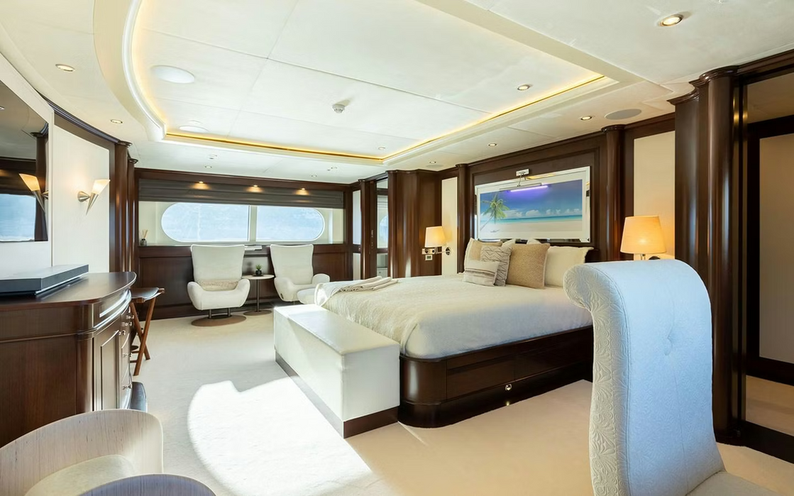 Spacious master suite on M/Y Maximilian MMIV with lounge seating and natural light