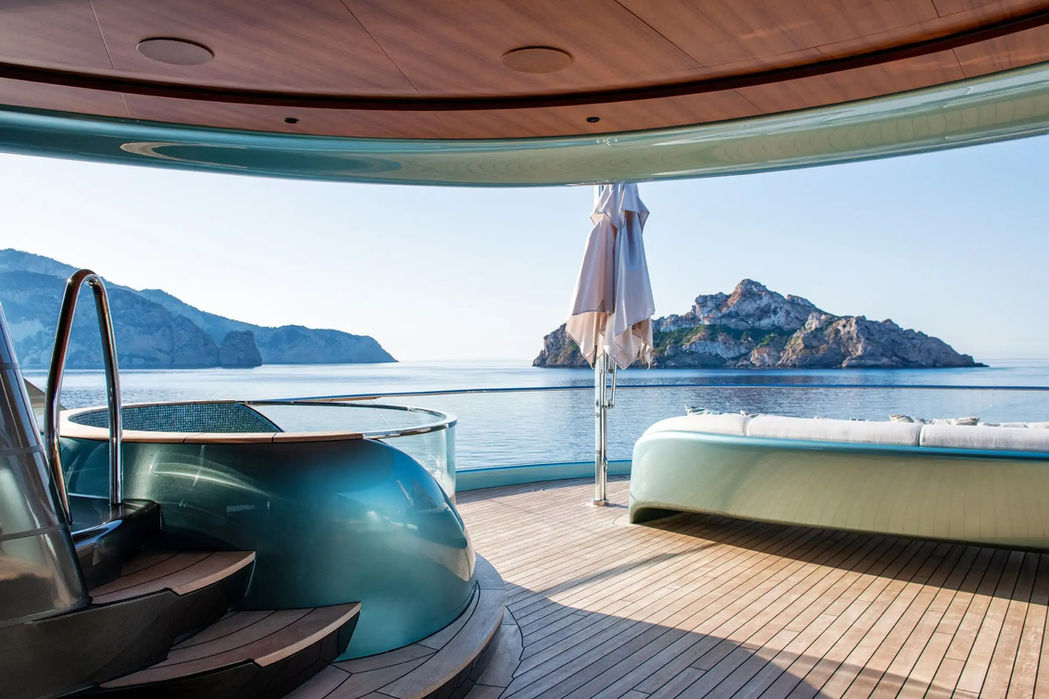 Rear deck view of Kenshō showcasing sun loungers and swim platform close to the water.