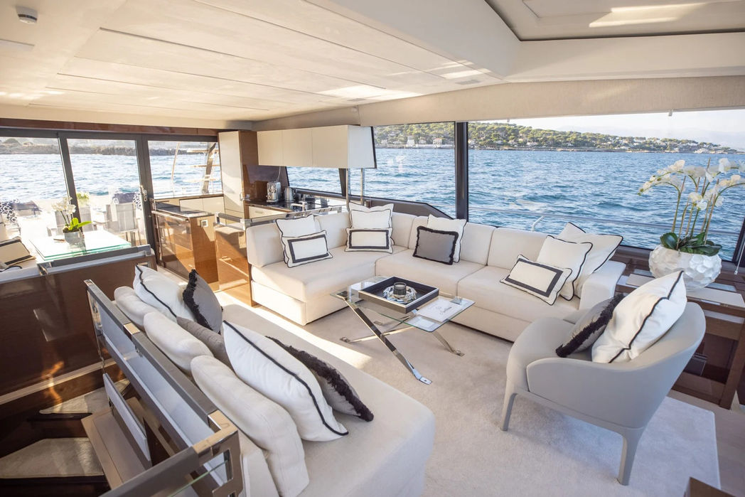 Bright and modern main salon aboard the Prestige G80S with panoramic views of the French Riviera