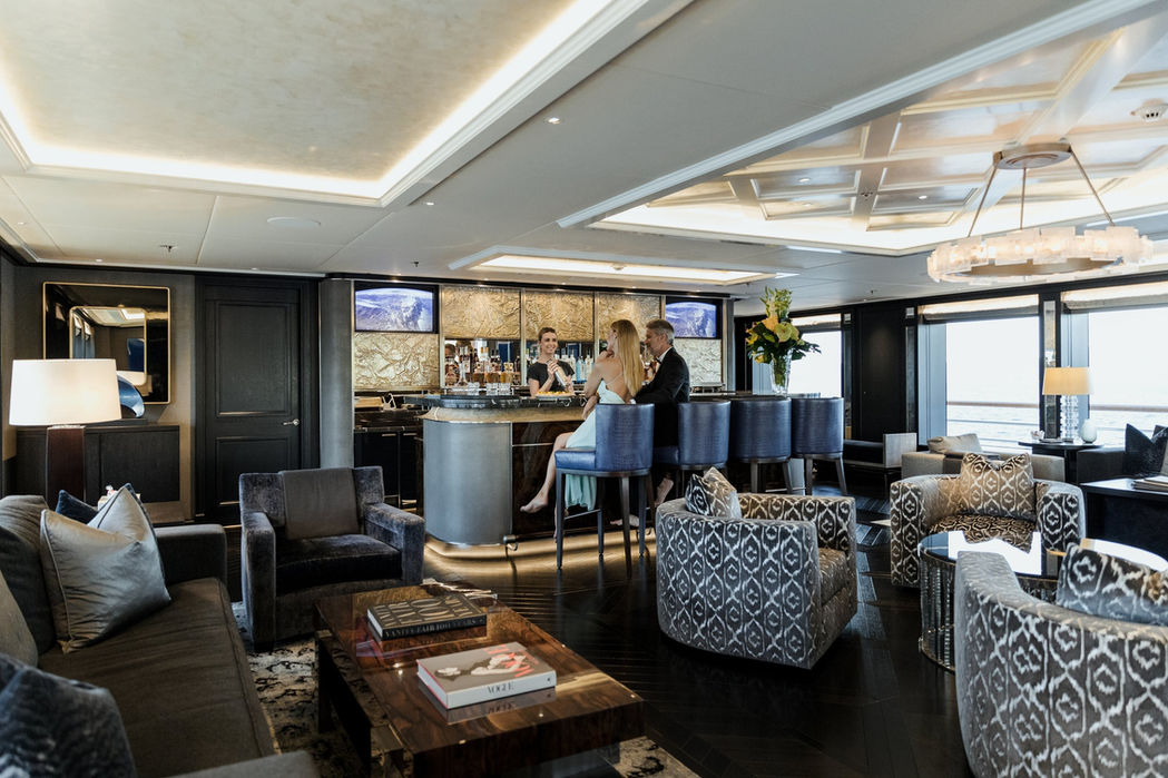 main salon aboard Aquila featuring plush seating and refined decor