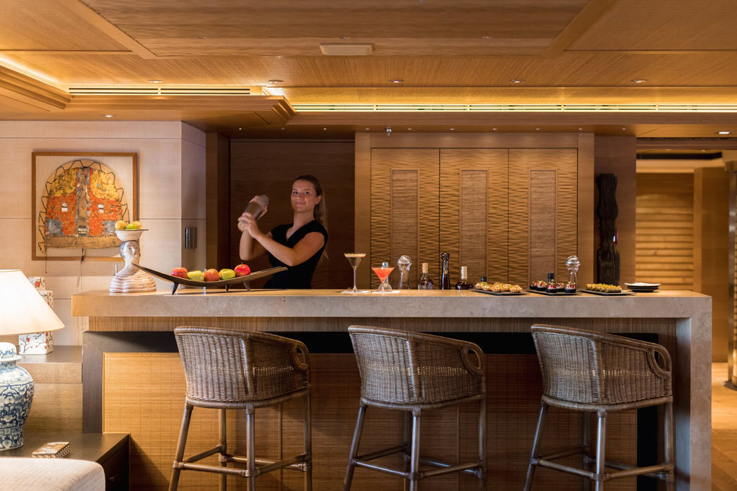 Elegant dining room inside the Naia superyacht with warm lighting and luxury finishes.