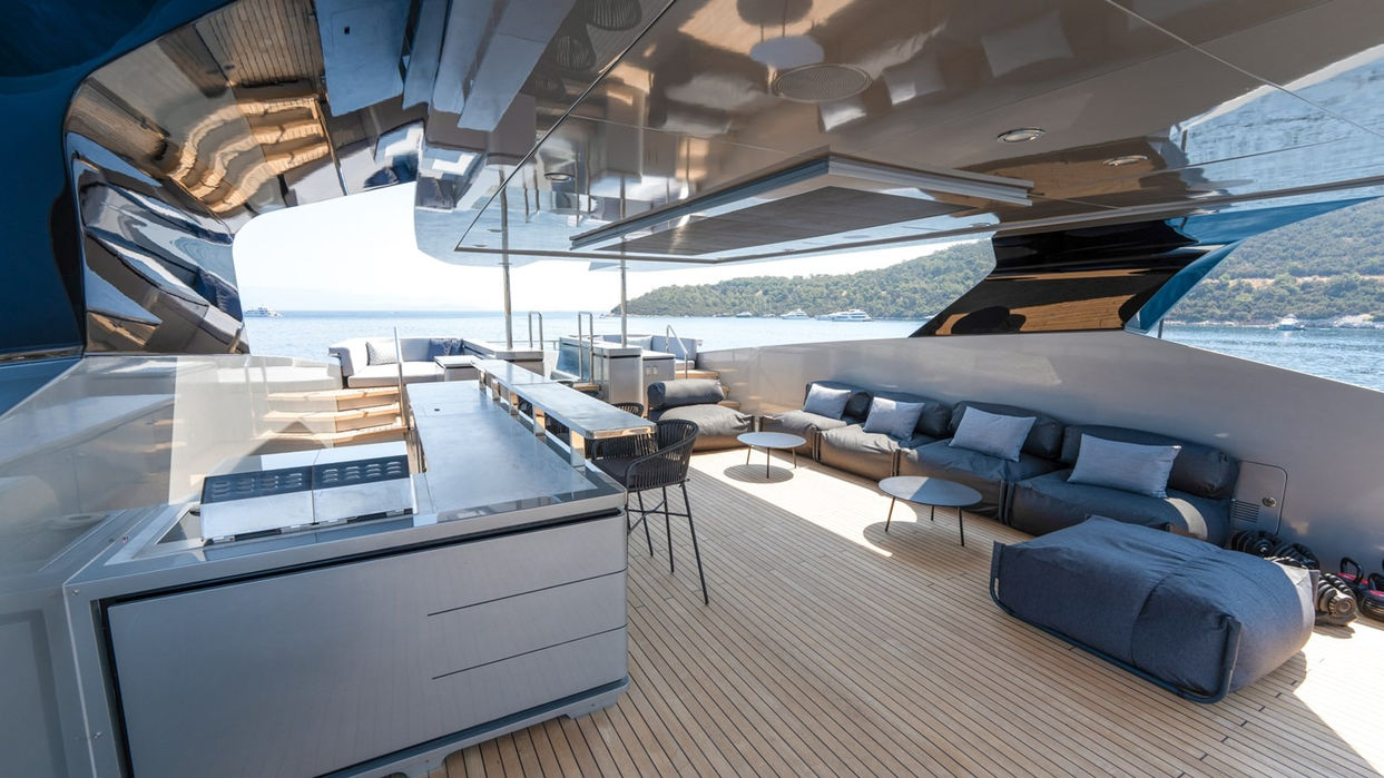 Open-air aft deck lounge aboard Provocateur, designed with modern seating and sea views for luxury outdoor living on the French Riviera.