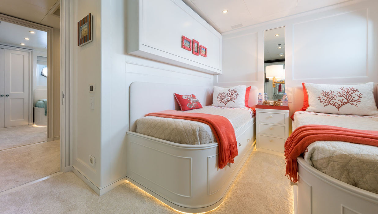 Convertible guest cabin on M/Y Bina with twin beds and colorful decor