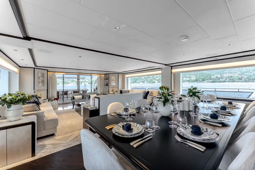 Contemporary open-plan salon on M/Y Optimism featuring large sea-view windows
