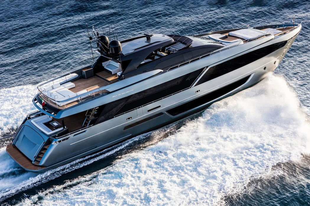 Riva 110 Dolcevita superyacht cutting through the water at high speed with a dramatic wake.