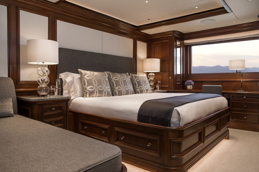 VIP stateroom aboard Aquila featuring warm interiors and large windows