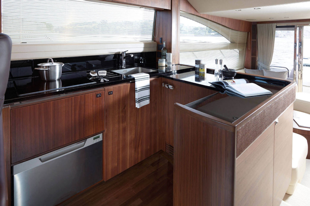 Fully equipped galley onboard Princess V56 featuring modern appliances for long-range charters