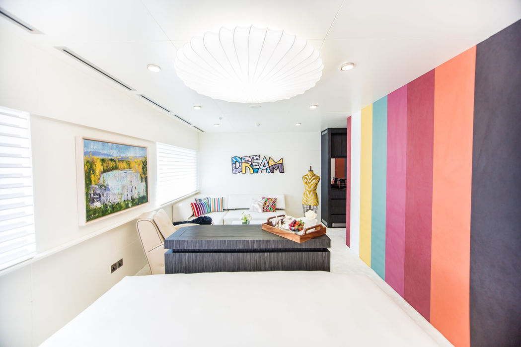 VIP stateroom on Saluzi superyacht featuring vibrant accent walls and modern decor.