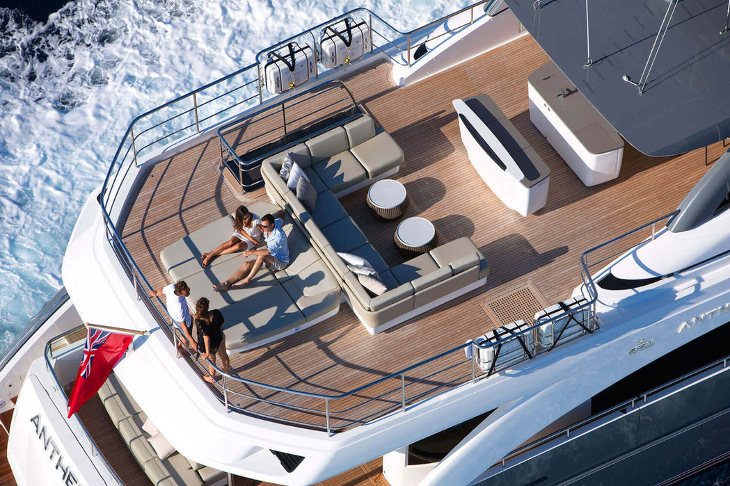 Flybridge of Princess 35M showing dining, sun loungers, and helm area from above.