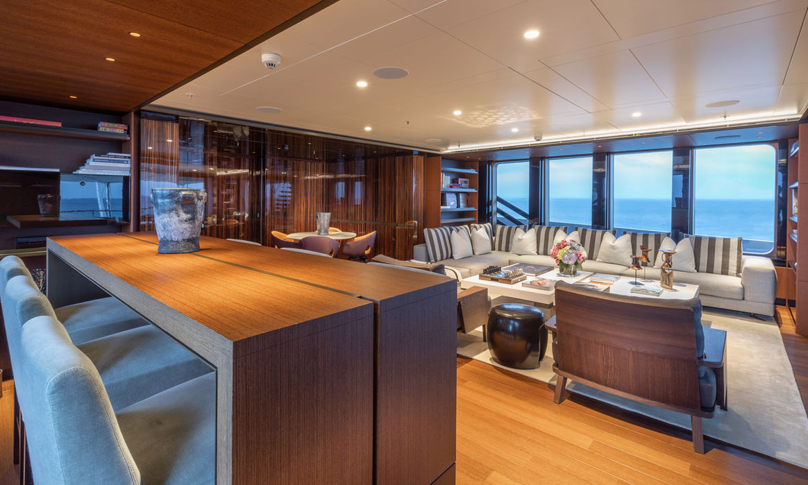 Evening atmosphere inside the main salon of M/Y HALO superyacht on charter with Navélia Yacht Charters