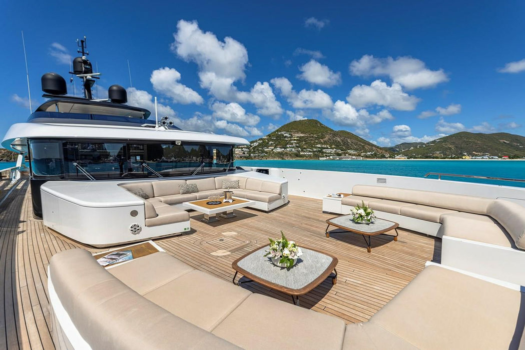 Luxury yacht Seven Sins sun deck seating with panoramic views of the coast