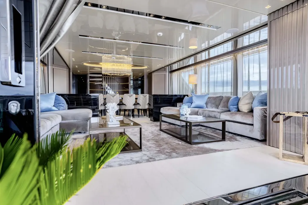 Main salon of Sabbatical yacht featuring full length windows and open seating