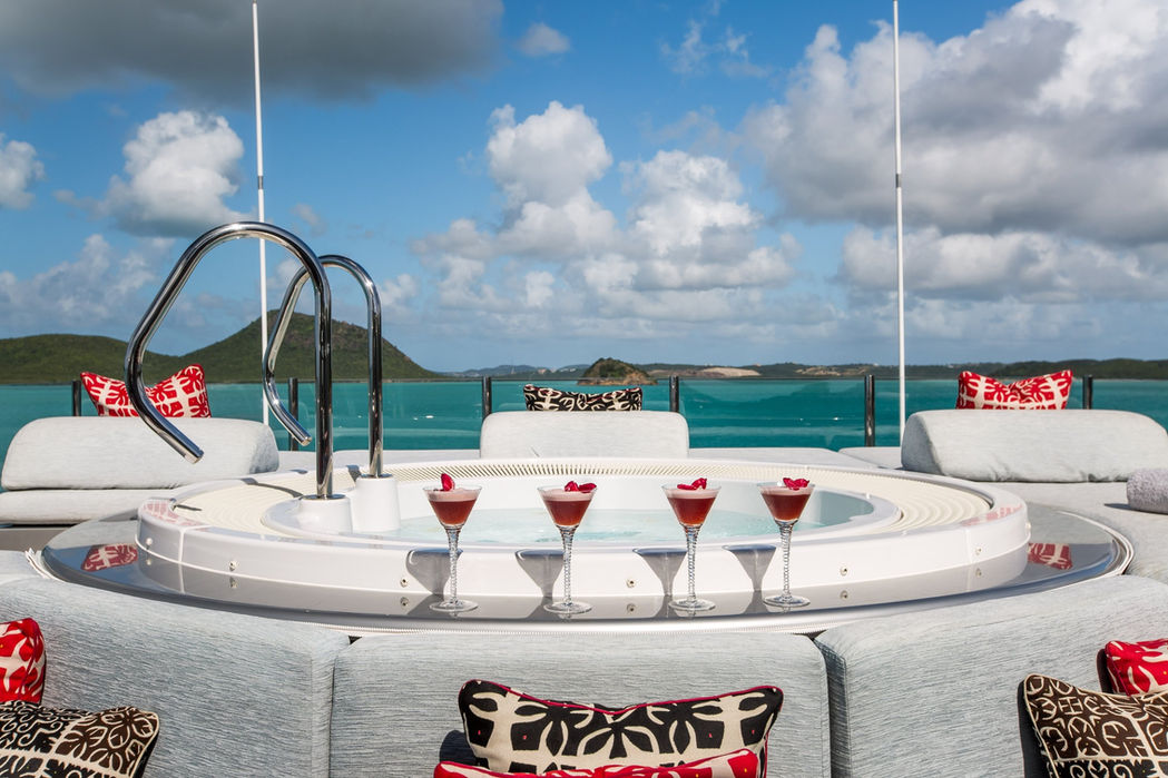Slipstream’s sundeck jacuzzi surrounded by cocktails and ocean backdrop