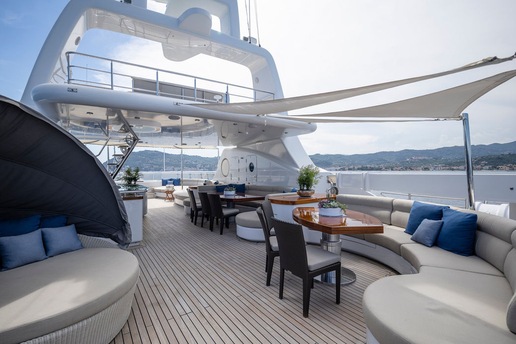 Luxury yacht Talisman Maiton upper deck outdoor lounge and dining area, Mediterranean cruising