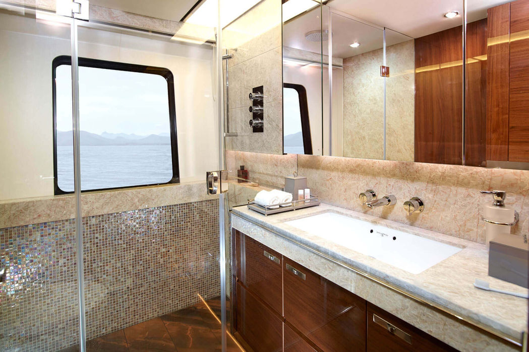 Bright guest bathroom on Princess 35M with glass shower and luxury vanity.