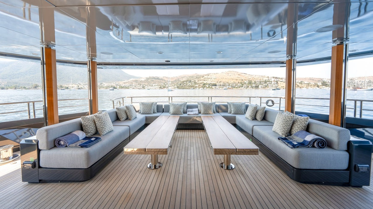 Open-air aft deck lounge with spacious seating on the Provocateur superyacht, ideal for sunset cruising off Saint-Tropez.