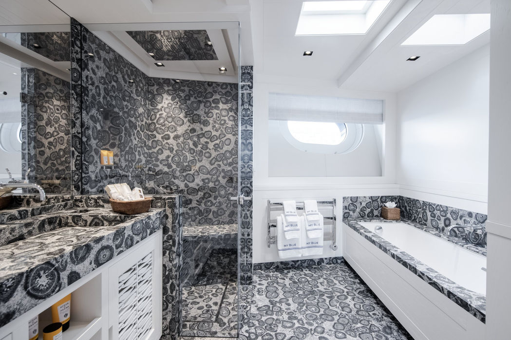 Ensuite bathroom on Blue II with marble finishes and bathtub