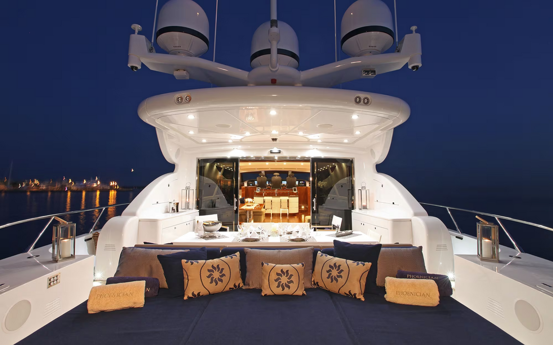 Evening view of Phoenician yacht stern lounge illuminated while anchored on the Riviera