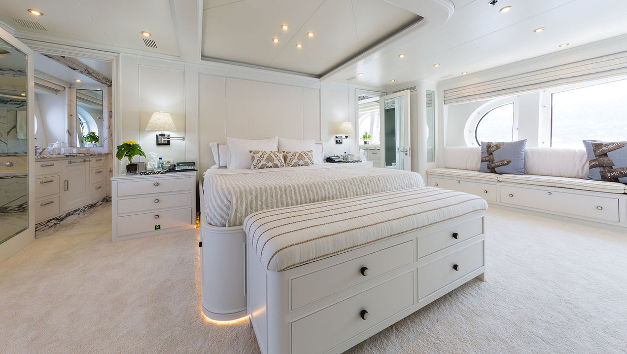 Master cabin on M/Y Bina offering a king bed and bright Mediterranean styling