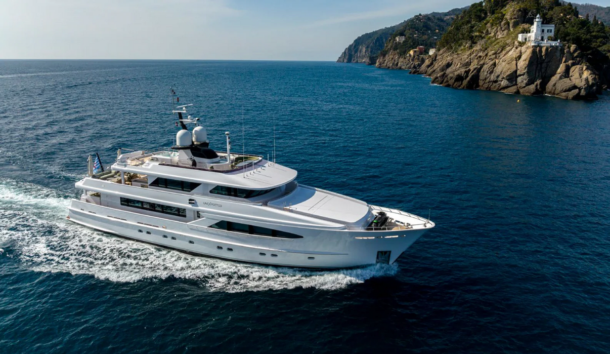 Elegant profile of M/Y Optimism cruising on calm Mediterranean waters
