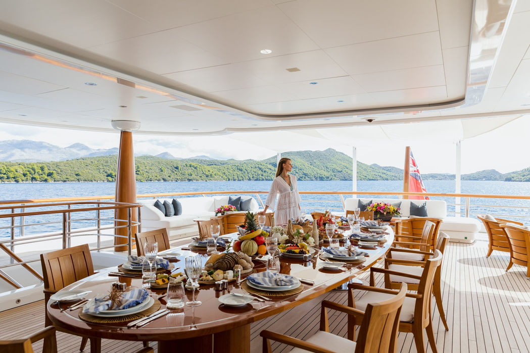 aft dining setup on Aquila superyacht with ocean views