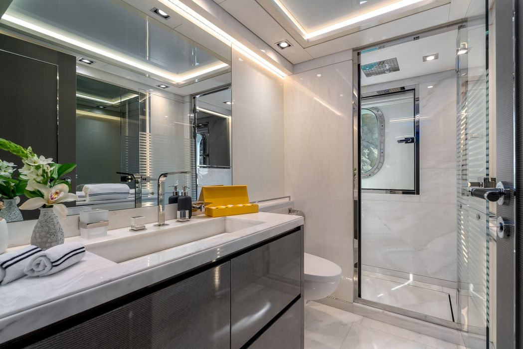 Bright ensuite bathroom on O’Mathilde with premium marble counters and glass shower.