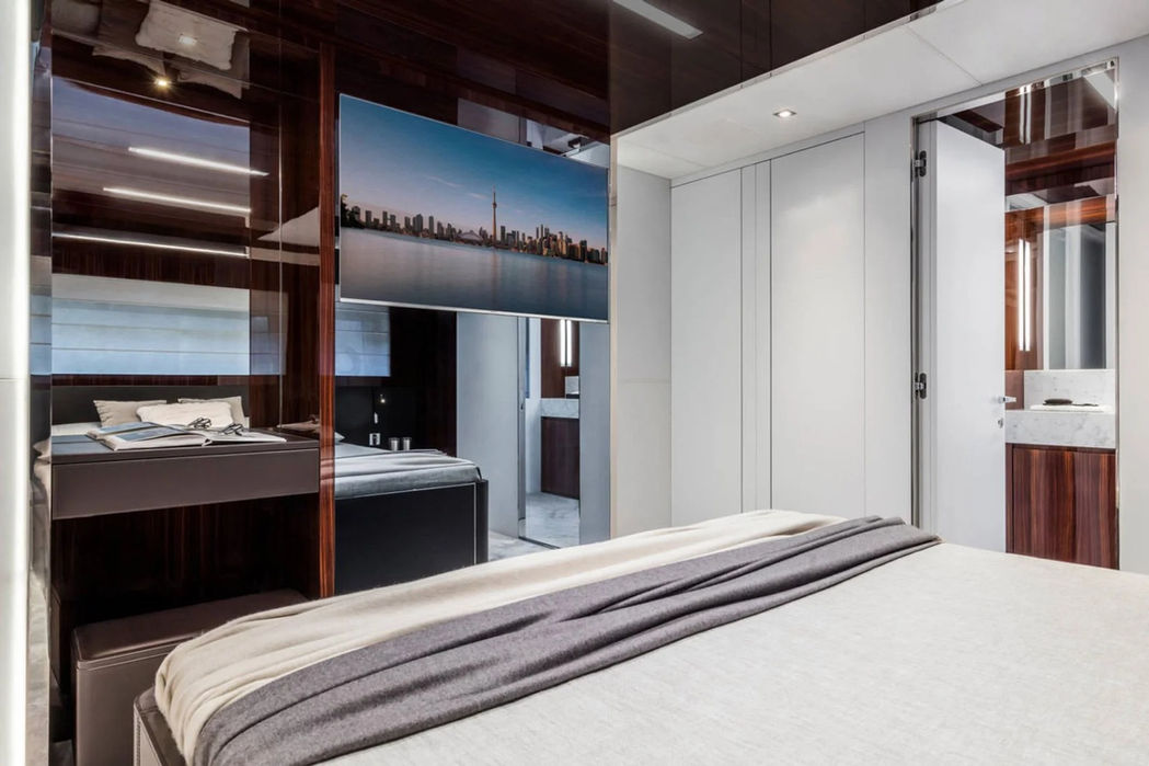 Bright master stateroom of the Riva 110 Dolcevita with full-height windows.