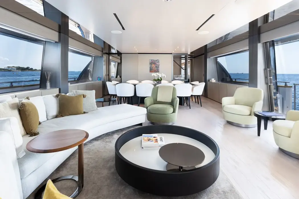 Spacious and stylish main salon on the Navetta 33 featuring neutral tones and circular seating arrangements.
