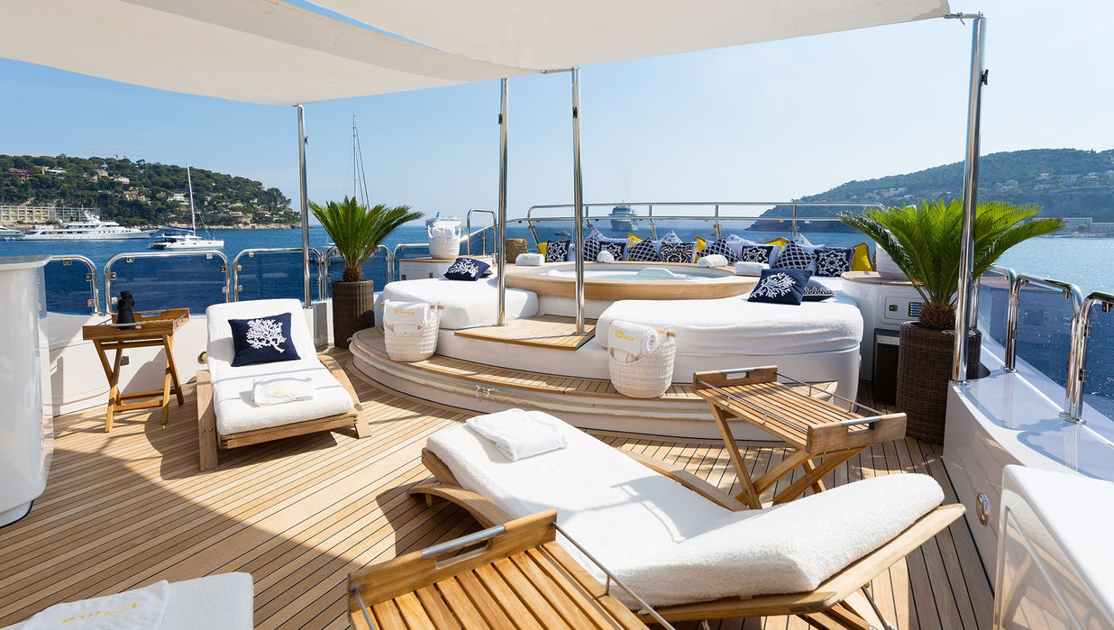 Upper deck lounge area on M/Y Bina arranged for Mediterranean outdoor relaxation
