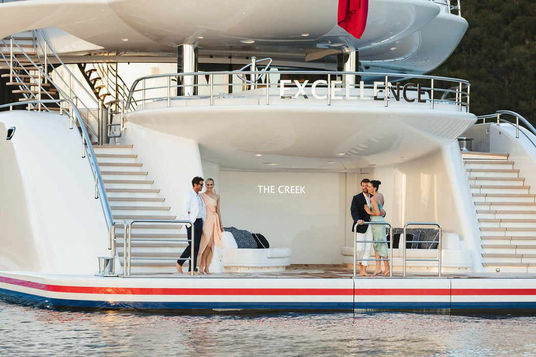 Wide staircase leading from the main deck to the swim platform aboard Excellence.