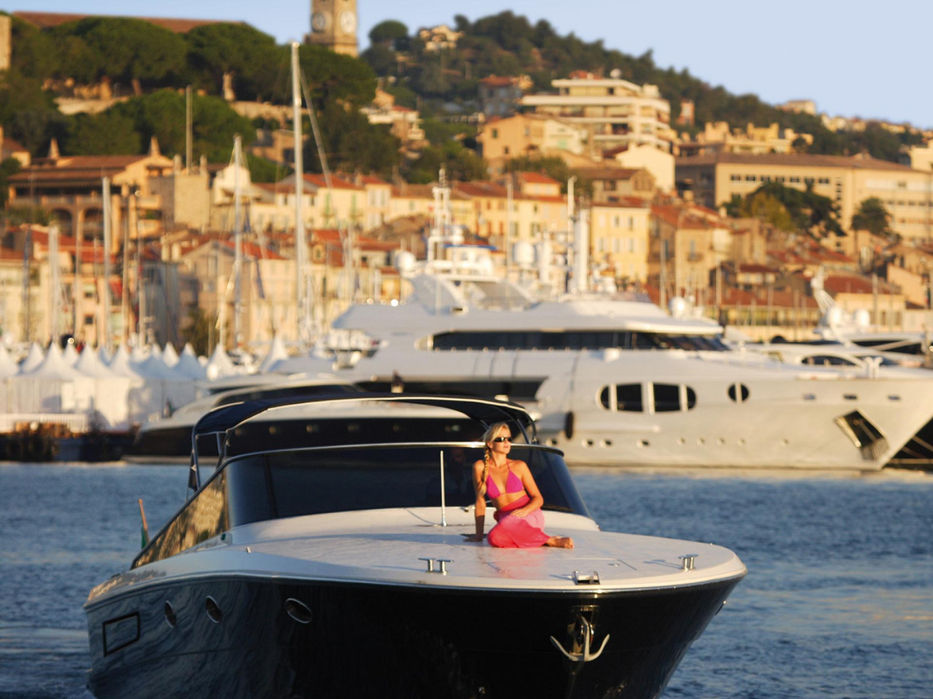 Luxury yacht cruising near a Riviera harbour close to Monaco during a day yacht charter.