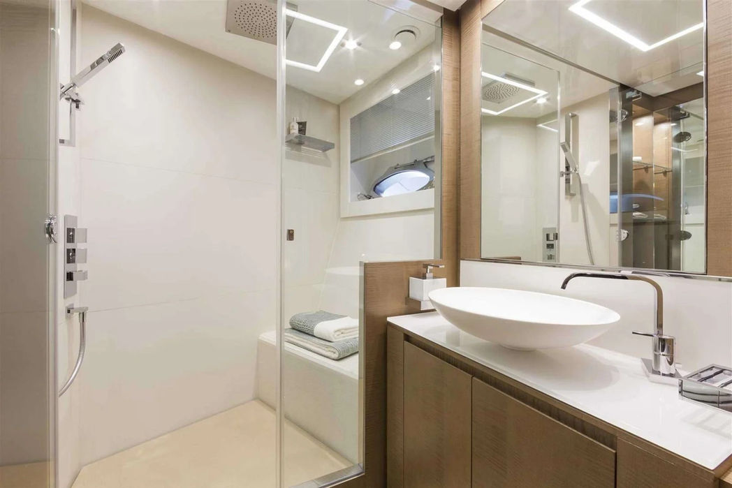 Modern ensuite bathroom aboard the Pershing 108 with premium fixtures and glass shower.