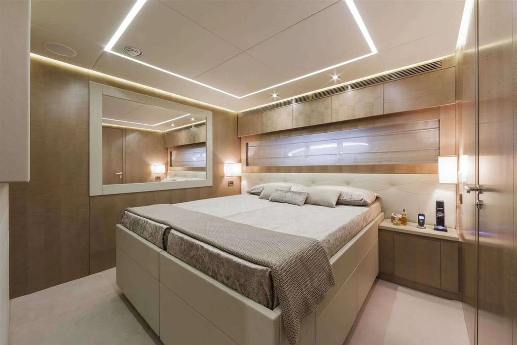 Elegant master cabin on the Pershing 108 with ambient lighting and large windows.