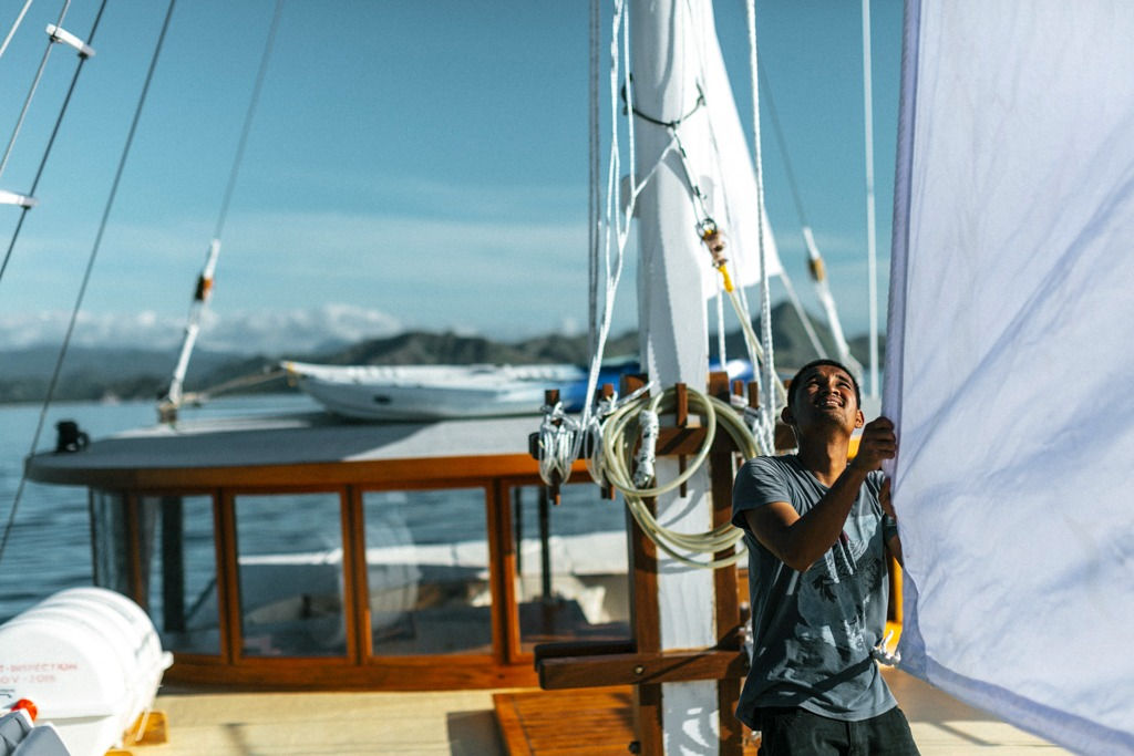 Crew working on deck onboard Leyla Phinisi luxury yacht during a Komodo charter with Navélia Yacht Charters Indonesia.