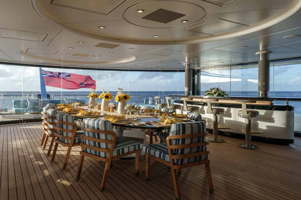 Circular sun deck lounge on Whisper superyacht with panoramic ocean views.