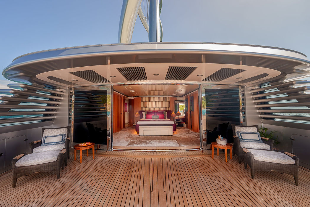 Grand aft entry staircase leading into a sailing superyacht’s main deck.