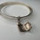 Thumbnail: Trio of sterling silver bangles with a locket