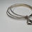Thumbnail: Trio of sterling silver bangles with a locket