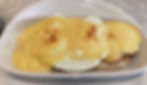 Eggs Benedict - Grilled English muffin with Canadian bacon and two basted eggs topped with hollandaise sauce. Served with three buttermilk pancakes.