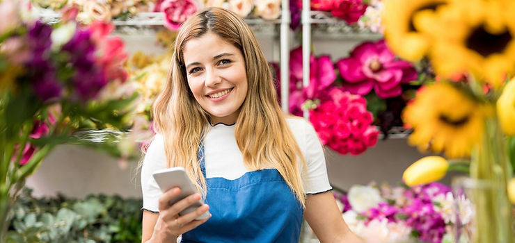 florist girl holding a telephone and smiling