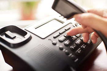 Picture of a hand dialing a telephone