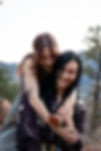 Two women laughing during a mountain engagement session in Colorado